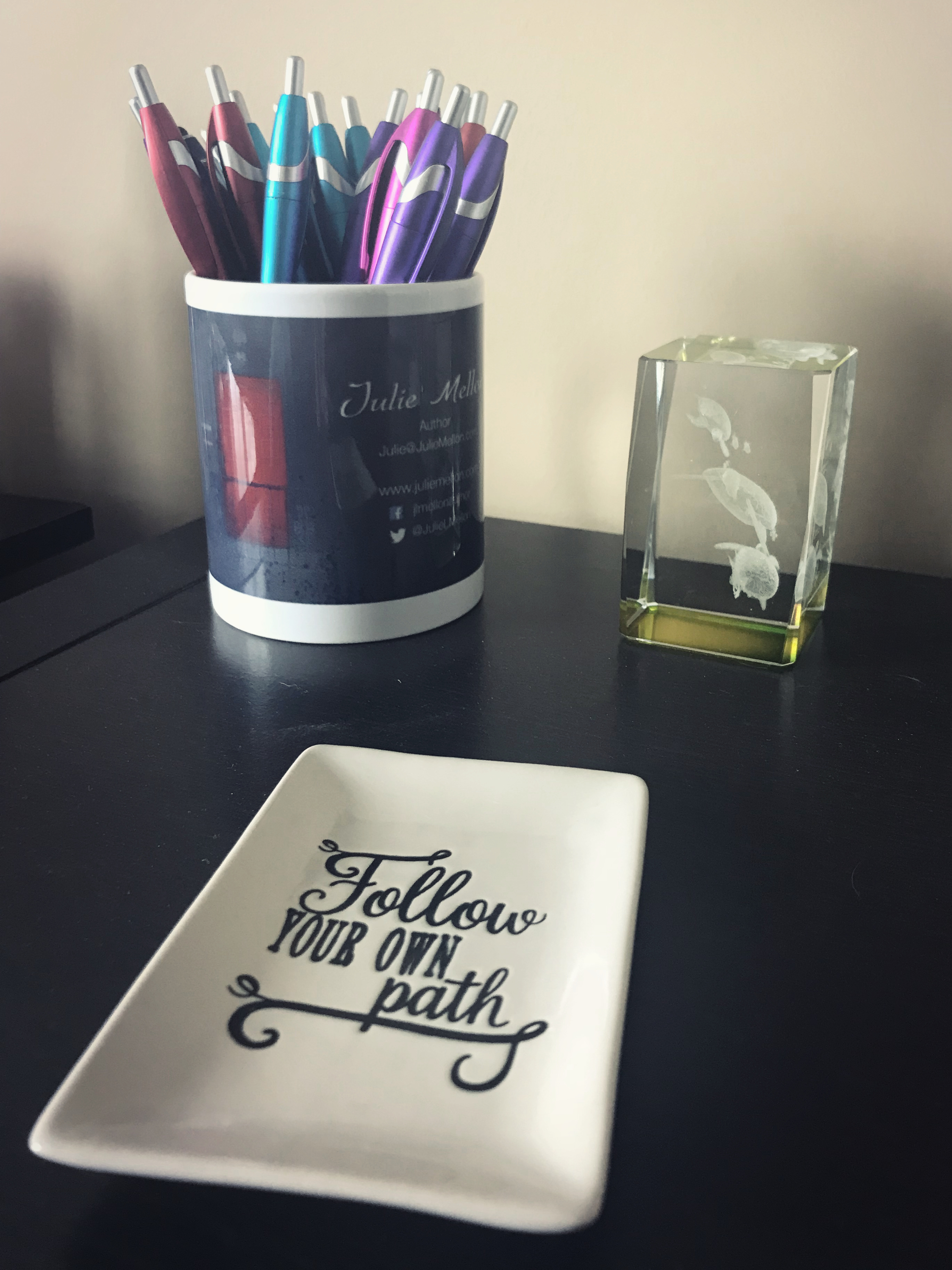photo of Julie Mellon mug with pens and inspiration quote on dish